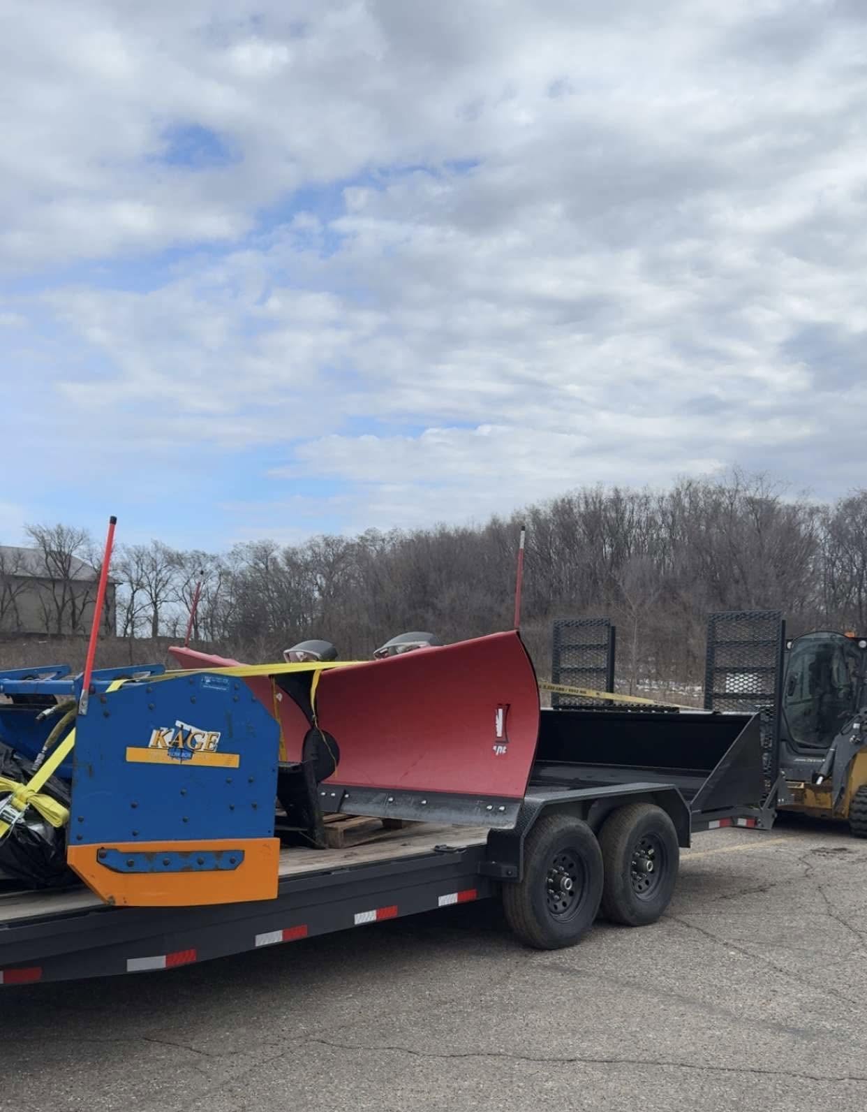 Snowplow blade and attachments loaded on a trailer