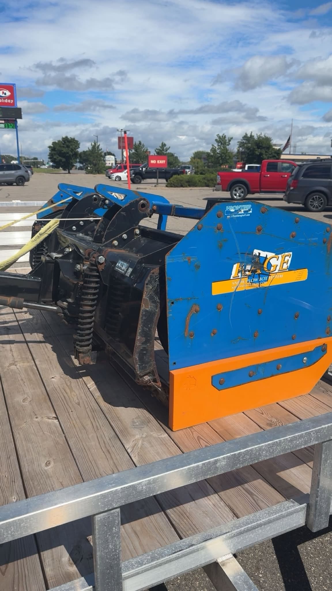 Snow pusher attachment secured on a trailer